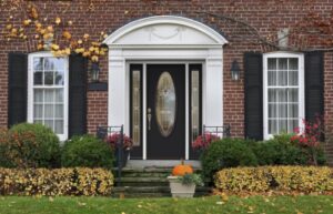 a front entry doors with oval-shaped glass pane and surrounding sidelites