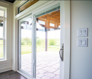 elegant patio doors overlooking a tile patio with pergola